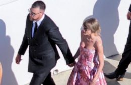 Taylor Swift and Travis Kelce arriving in elegant formal attire at JuJu Smith-Schuster's wedding, showcasing coordinated fashion during one of their first public appearances after their reported wedding celebrations.