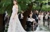 Model wearing Dior Fall/Winter 2026–2027 Haute Couture Look 57, featuring a white silk chiffon ensemble embroidered with cactus flowers and finished with artistic frayed edges.
