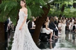 Model wearing Dior Fall/Winter 2026–2027 Haute Couture Look 57, featuring a white silk chiffon ensemble embroidered with cactus flowers and finished with artistic frayed edges.