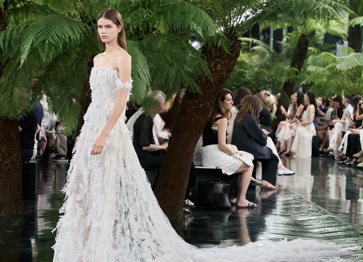 Model wearing Dior Fall/Winter 2026–2027 Haute Couture Look 57, featuring a white silk chiffon ensemble embroidered with cactus flowers and finished with artistic frayed edges.