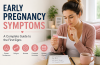 Woman holding a pregnancy test while learning about early pregnancy symptoms
