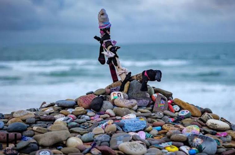 Harry Potter fans visit the Dobby memorial at Freshwater West beach in Wales, the filming location associated with Dobby’s grave.