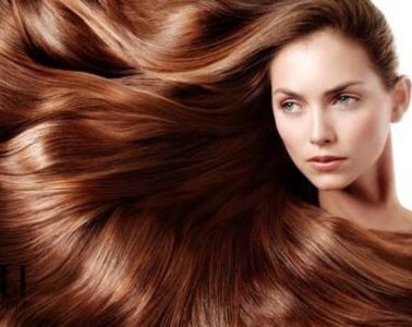 Woman with long healthy shiny hair following an everyday hair care routine
