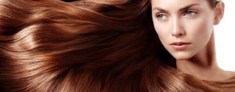 Woman with long healthy shiny hair following an everyday hair care routine