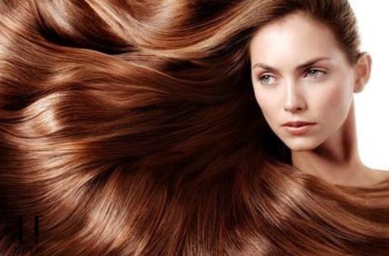 Woman with long healthy shiny hair following an everyday hair care routine