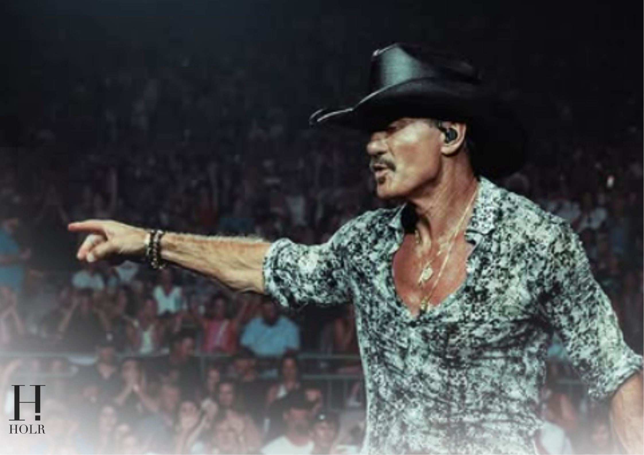 Tim McGraw performs onstage during his Cincinnati concert before taking a fall