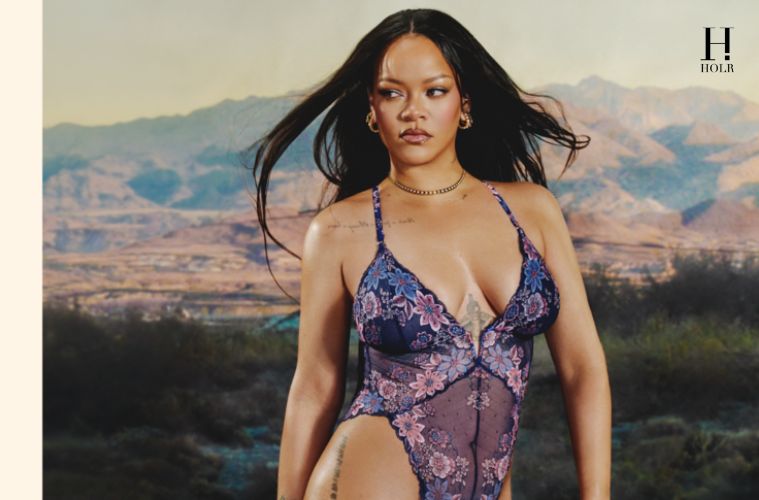 Rihanna poses behind a construction barricade in a floral Savage X Fenty teddy from the Curves Ahead campaign.