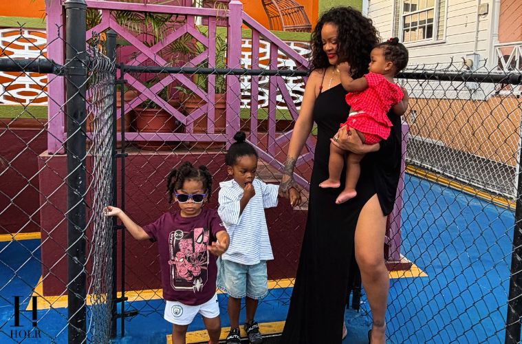 Rihanna stands with her children outside her childhood neighborhood on Rihanna Drive in Barbados.