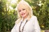 Dolly Parton smiles during a professional portrait as the country music legend is remembered following her death at 80.