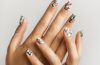 A minimalist animal-print manicure featuring subtle leopard, zebra, crocodile, and cow-inspired nail designs.