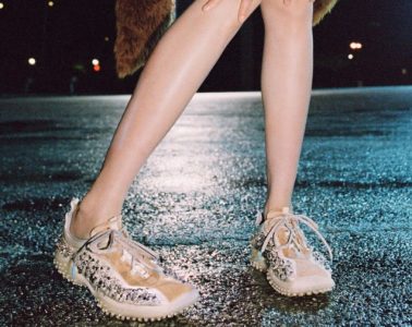 A fashion-forward look featuring archival-inspired shoes alongside modern clothing in a contemporary street-style setting.