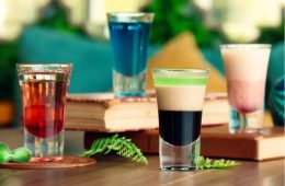 A selection of colorful modern beverages featuring sparkling fruit drinks, botanical sodas, tea, and alcohol-free spritzes.