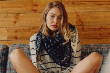 A woman wearing a paisley bandana-print outfit with denim and accessories styled for the transition from summer to fall.