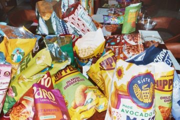 A colorful assortment of innovative savory snacks, sweet treats, chips, pretzels, nuts, fruit bars, and candies.