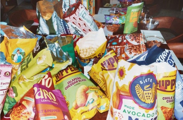 A colorful assortment of innovative savory snacks, sweet treats, chips, pretzels, nuts, fruit bars, and candies.