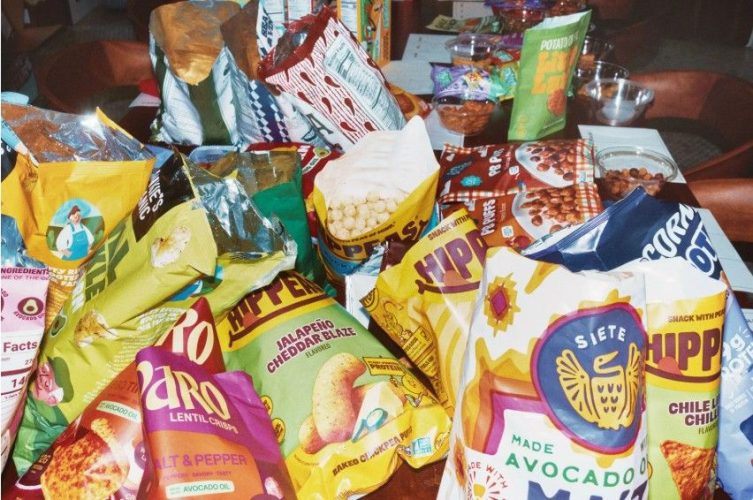 A colorful assortment of innovative savory snacks, sweet treats, chips, pretzels, nuts, fruit bars, and candies.