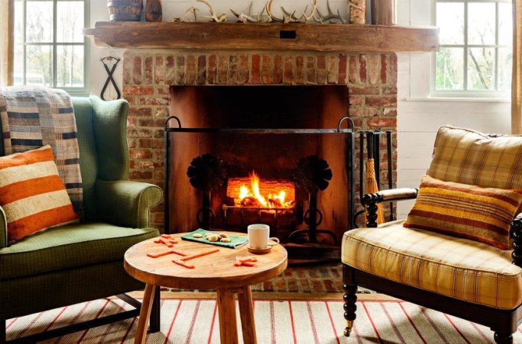 A cozy home interior styled for early fall with warm textiles, natural décor, seasonal accents, and framed artwork.