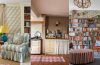 An English cottage-inspired interior featuring floral patterns, natural textures, vintage furniture, and collected decorative details.