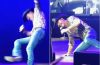 Tim McGraw performs onstage during his Cincinnati concert before falling after his cowboy boot catches on the stage floor.