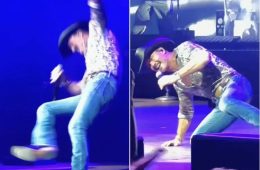 Tim McGraw performs onstage during his Cincinnati concert before falling after his cowboy boot catches on the stage floor.
