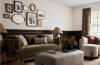 Vintage-inspired home interior featuring traditional décor, brass accents, artwork, curtains, and classic furniture.