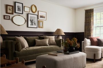 Vintage-inspired home interior featuring traditional décor, brass accents, artwork, curtains, and classic furniture.