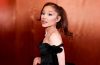 Ariana Grande addresses fans on stage while explaining her decision to take a planned break from public visibility.
