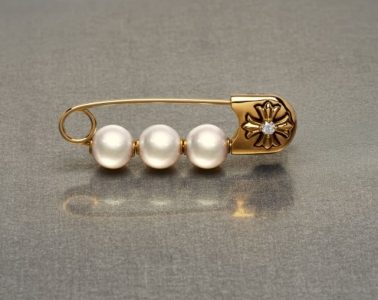 Pearl jewelry styled with gothic metal details, safety pins and layered chains for a modern punk-inspired look.