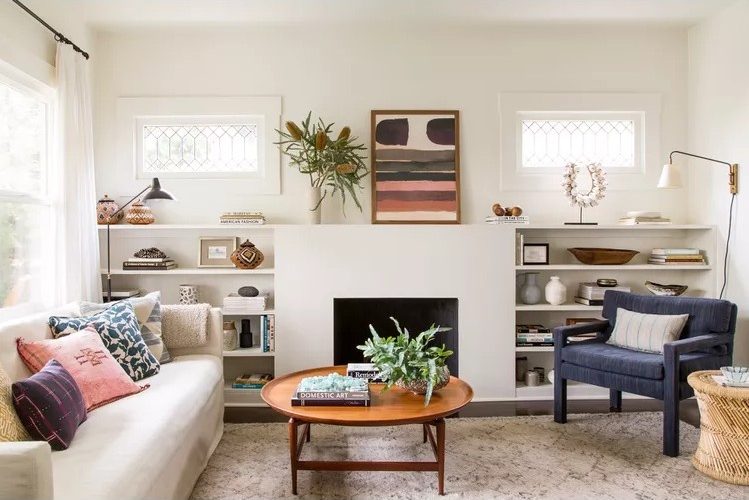 A warm and inviting living room featuring layered lighting, comfortable textiles, greenery and thoughtful decorative accents.