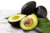 Fresh avocado halves and sliced avocado served as part of a colorful heart-healthy meal.