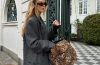 A selection of leopard and cheetah-print handbags styled with neutral fall clothing and everyday accessories.