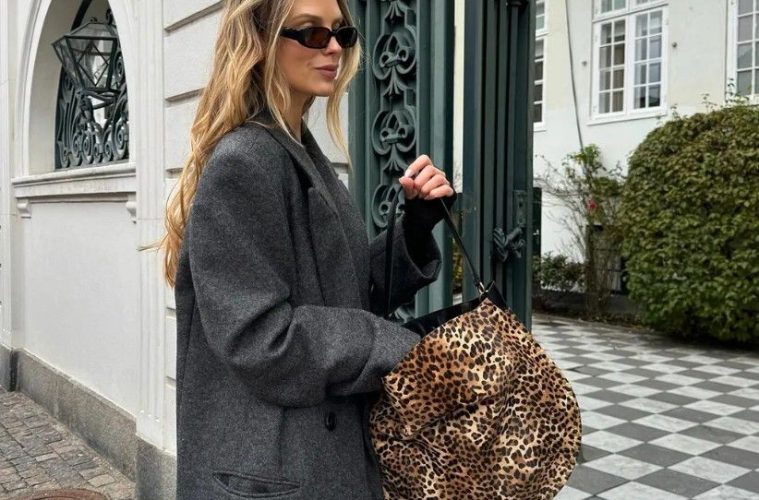 A selection of leopard and cheetah-print handbags styled with neutral fall clothing and everyday accessories.