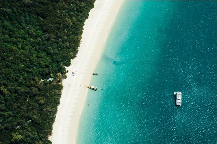 Aerial view of Whitehaven Beach in Australia with brilliant white silica sand and turquoise water.