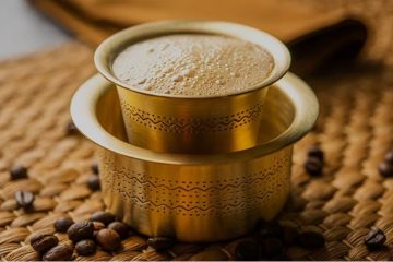 Traditional South Indian filter coffee served in a stainless-steel tumbler and dabara with frothy milk coffee.