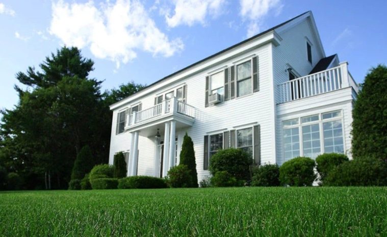 Healthy green lawn being watered efficiently during hot summer weather.