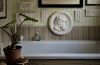 Modern interior featuring Ancient Greek-inspired design elements, natural stone, sculptural decor, and classical geometric details.
