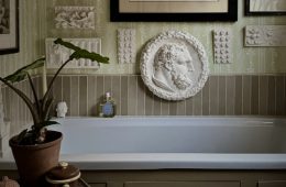 Modern interior featuring Ancient Greek-inspired design elements, natural stone, sculptural decor, and classical geometric details.