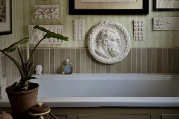 Modern interior featuring Ancient Greek-inspired design elements, natural stone, sculptural decor, and classical geometric details.