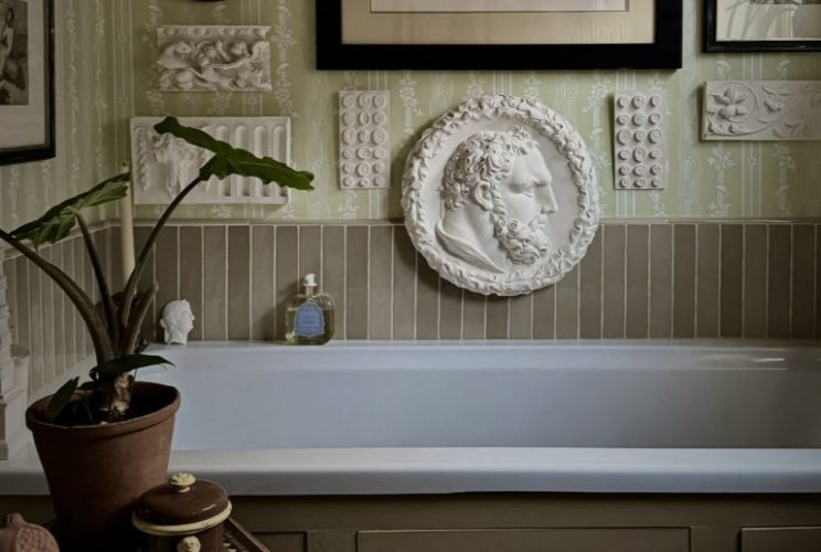 Modern interior featuring Ancient Greek-inspired design elements, natural stone, sculptural decor, and classical geometric details.