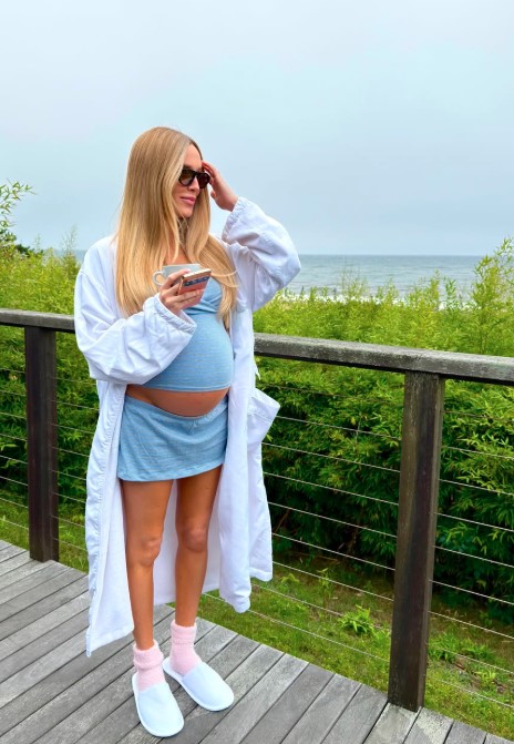 Alex Cooper Shows Off Her Baby Bump in New York City as She Says There’s “Lotssss of Pink & Blue These Days”
