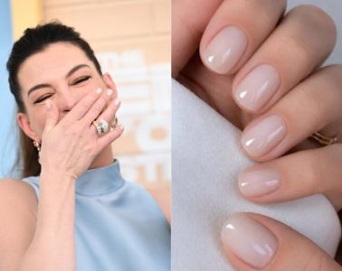 Anne Hathaway showcases short, glossy coconut water nails with a sheer creamy finish and subtle shine.