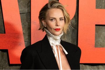 A woman wears a sleek stacked bob with shorter graduated layers at the back and a softly rounded shape that creates the appearance of fuller hair.