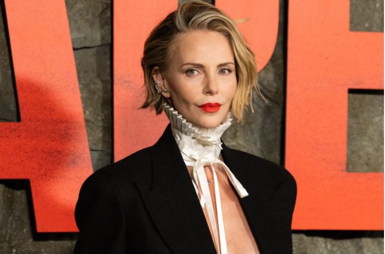 A woman wears a sleek stacked bob with shorter graduated layers at the back and a softly rounded shape that creates the appearance of fuller hair.