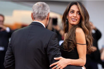 Amal Clooney shows off a short, glossy pink manicure while appearing on the Venice Film Festival red carpet.