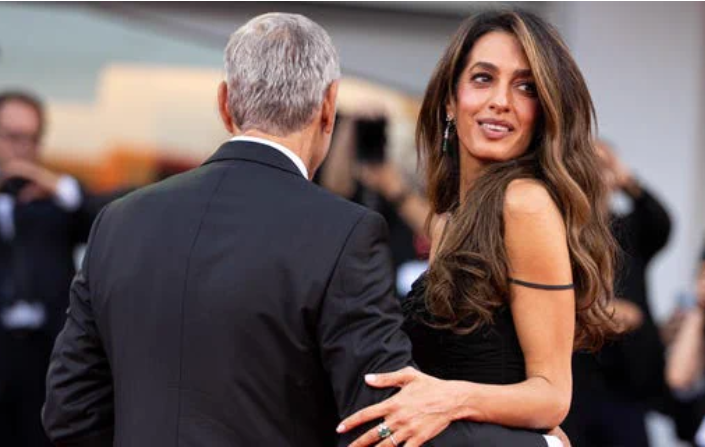 Amal Clooney shows off a short, glossy pink manicure while appearing on the Venice Film Festival red carpet.