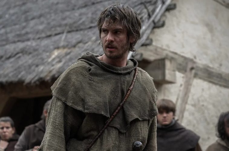 Andrew Garfield as Ploughman stands amid a tense medieval crowd in The Uprising, a gritty drama about England’s Peasants’ Revolt.