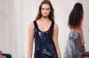 A Ralph Lauren Spring 2027 runway look combines polished tailoring with romantic details during the designer’s New York Fashion Week presentation.