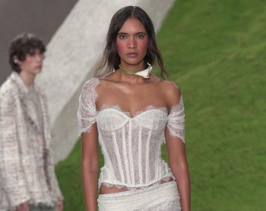 A Cult Gaia runway model wears a loose romantic ponytail and softly flushed berry-toned makeup with a dreamy, afterglow-inspired finish.